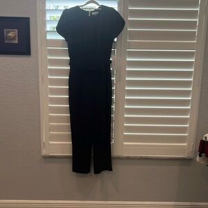 Black Jumpsuit New with Tags. With Pockets and short sleeves.
